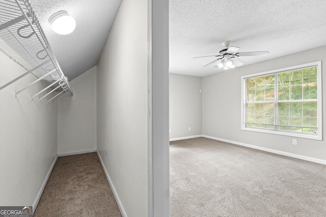 spacious closet with carpet flooring and ceiling fan