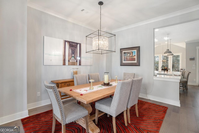 dining room featuring crown molding and dark wood-type flooring