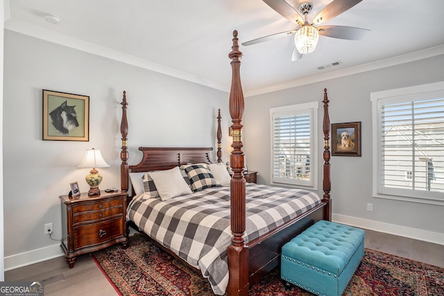 bedroom with ceiling fan, wood-type flooring, and ornamental molding