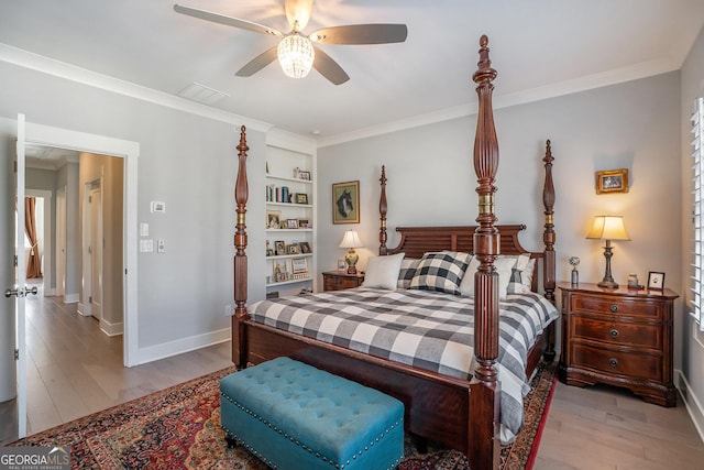 bedroom featuring ceiling fan, ornamental molding, and light hardwood / wood-style flooring