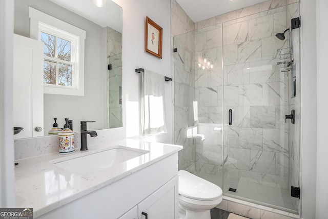 bathroom with vanity, toilet, and an enclosed shower