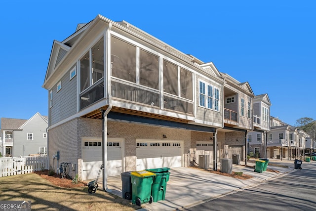 view of front facade with a garage and central air condition unit