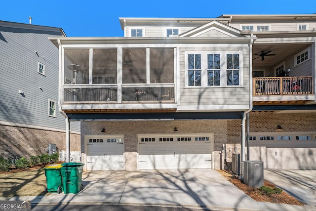 back of house featuring a garage and central air condition unit