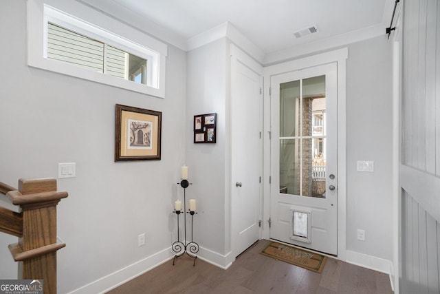 entrance foyer with crown molding and wood-type flooring