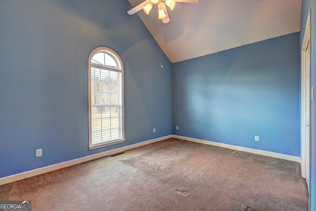 carpeted empty room with ceiling fan and high vaulted ceiling