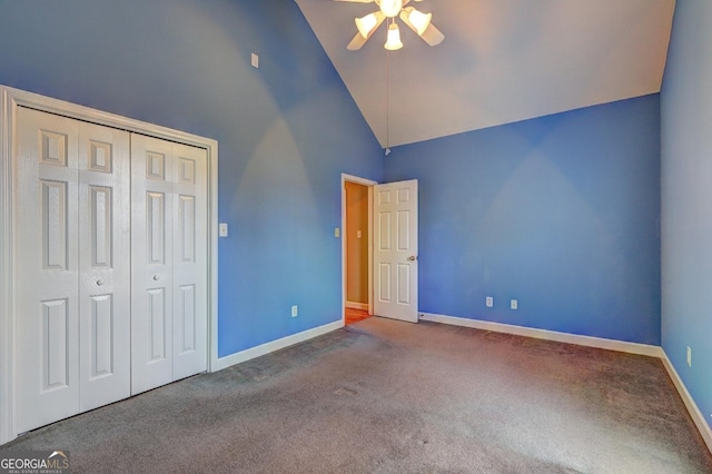 unfurnished bedroom featuring carpet floors, a closet, high vaulted ceiling, and ceiling fan