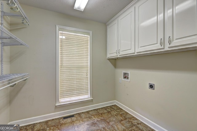 laundry room featuring cabinets, washer hookup, a textured ceiling, and hookup for an electric dryer