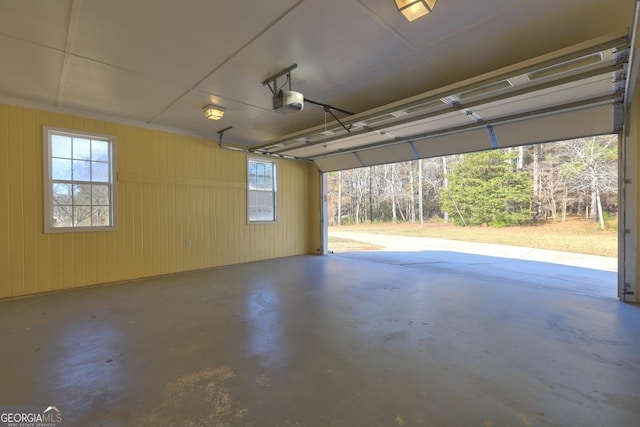 garage with wooden walls and a garage door opener