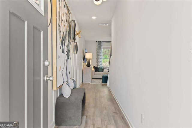 foyer entrance featuring a chandelier and light wood-type flooring