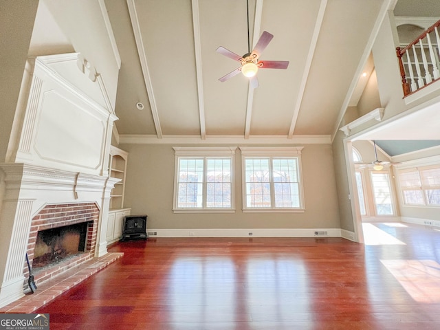 unfurnished living room with ceiling fan, vaulted ceiling, hardwood / wood-style floors, and a fireplace