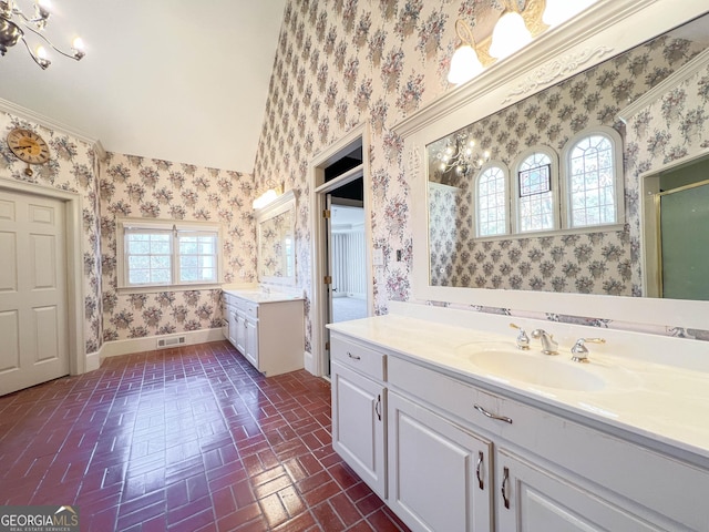 bathroom with vanity, crown molding, and walk in shower