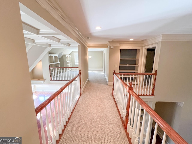 hall with coffered ceiling, crown molding, built in features, light colored carpet, and beam ceiling