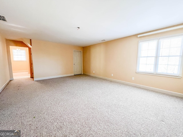 carpeted spare room featuring a wealth of natural light