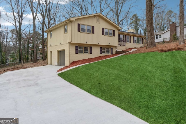 rear view of house featuring a yard, a garage, and a sunroom