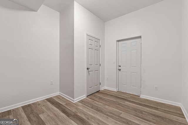 spare room with hardwood / wood-style flooring