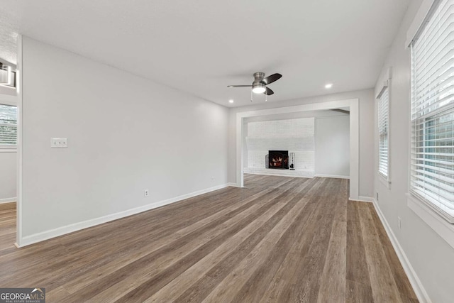 unfurnished living room with ceiling fan and hardwood / wood-style floors