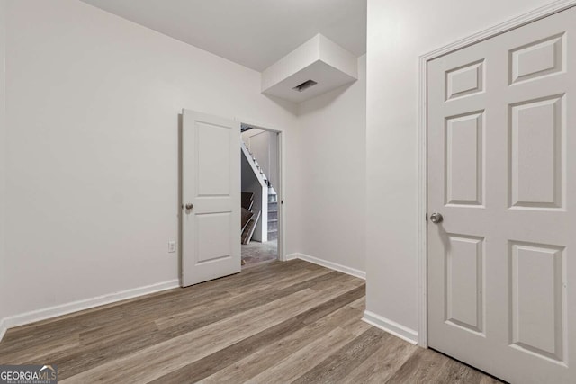 unfurnished bedroom with light wood-type flooring