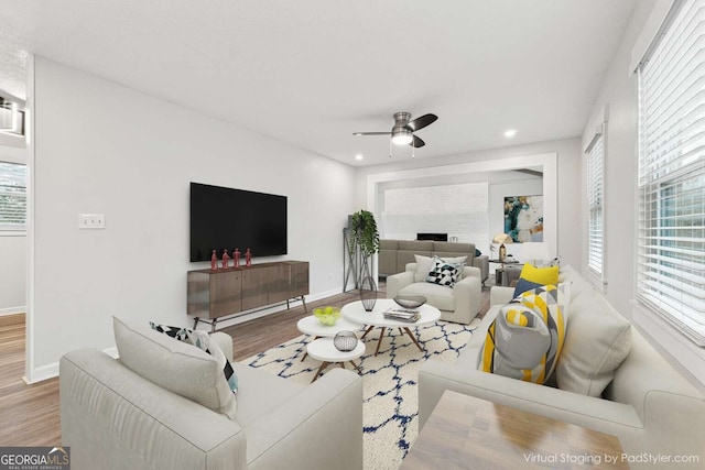 living room with ceiling fan and hardwood / wood-style flooring