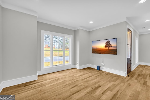 spare room with light hardwood / wood-style floors and ornamental molding