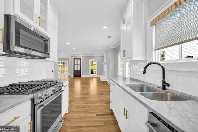 kitchen featuring white cabinets, stainless steel appliances, and sink