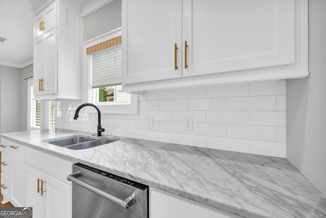 kitchen with dishwasher, sink, light stone countertops, tasteful backsplash, and white cabinetry