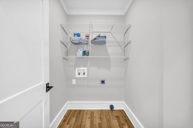 washroom featuring washer hookup, hookup for an electric dryer, crown molding, and hardwood / wood-style floors