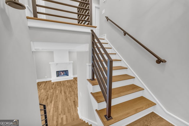 stairs featuring wood-type flooring