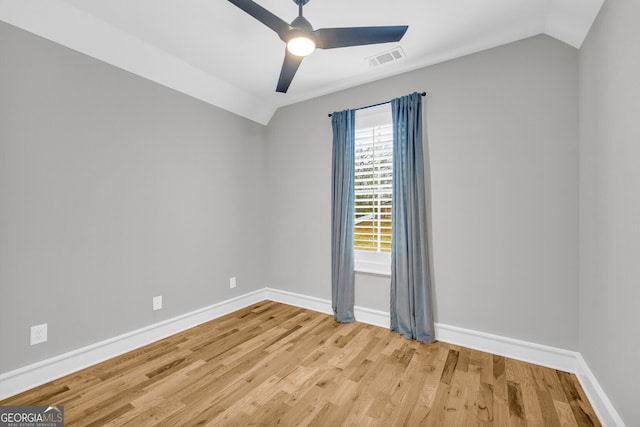 spare room featuring ceiling fan, light hardwood / wood-style flooring, and vaulted ceiling