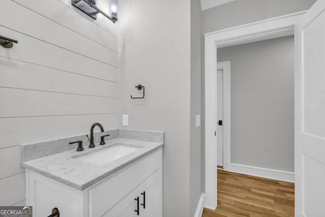 bathroom with hardwood / wood-style floors and vanity