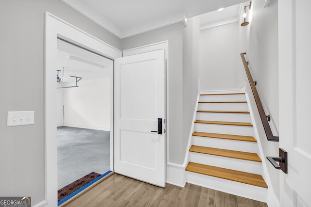 stairway with hardwood / wood-style floors