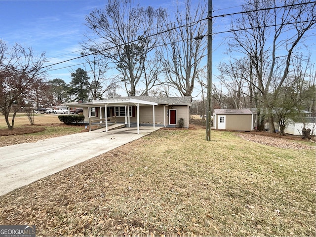 view of front of house with a carport, a shed, and a front yard