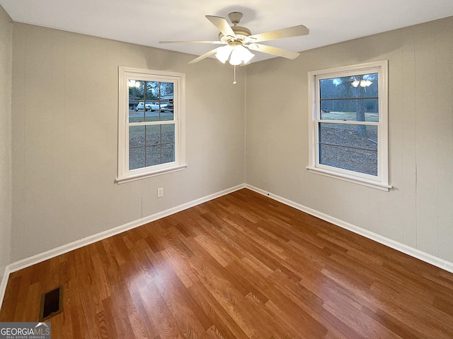 empty room featuring ceiling fan and hardwood / wood-style floors