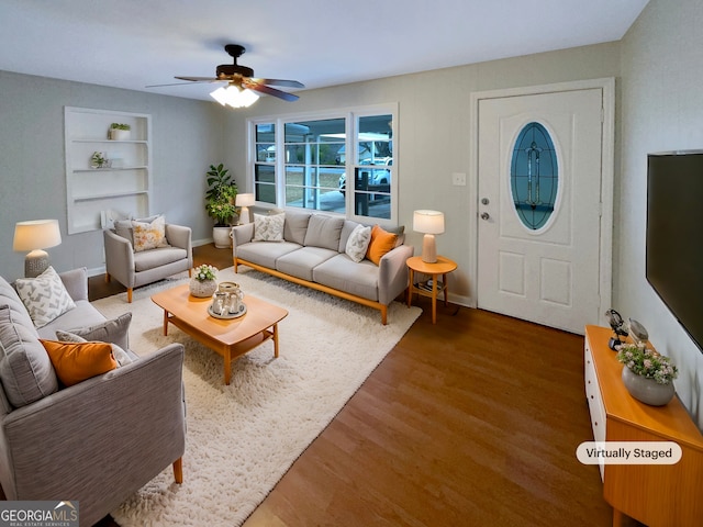 living room featuring built in shelves, ceiling fan, and hardwood / wood-style floors