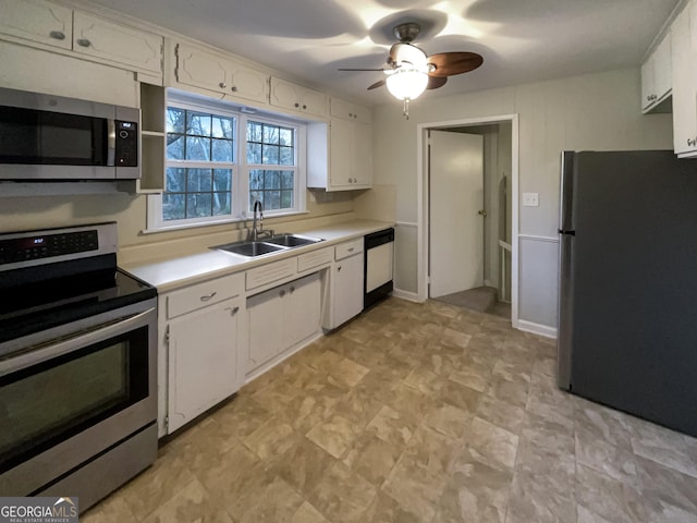 kitchen with white cabinets, stainless steel appliances, ceiling fan, and sink