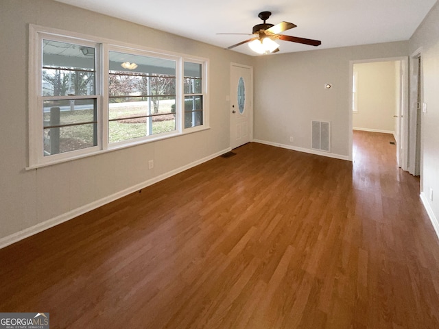 unfurnished room featuring ceiling fan and dark hardwood / wood-style floors