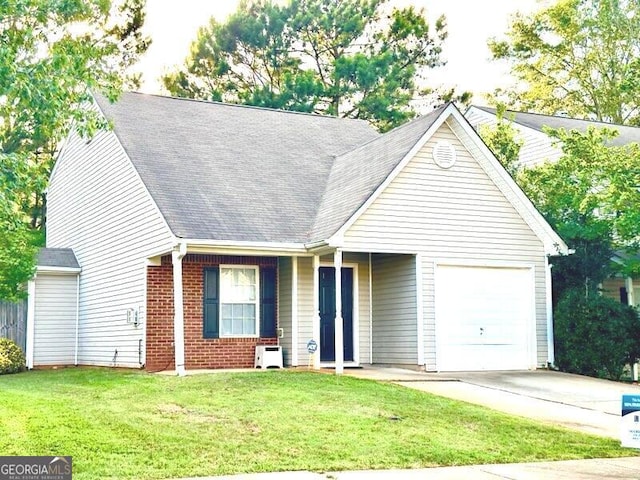 view of front of home with a front yard and a garage