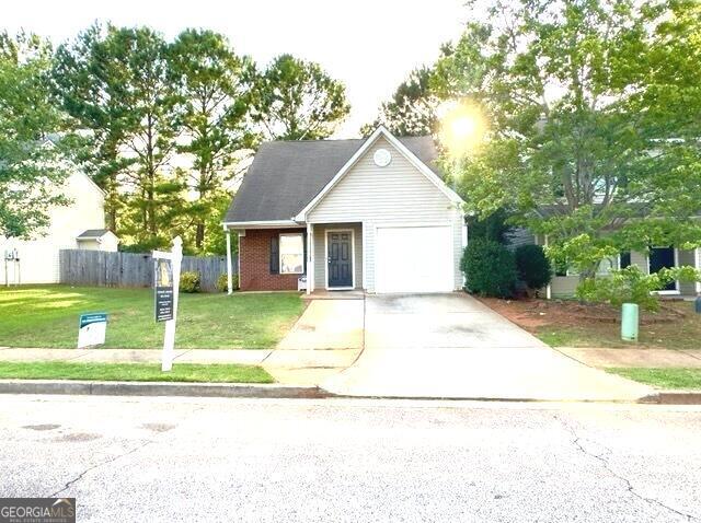 view of front of house with a front yard and a garage