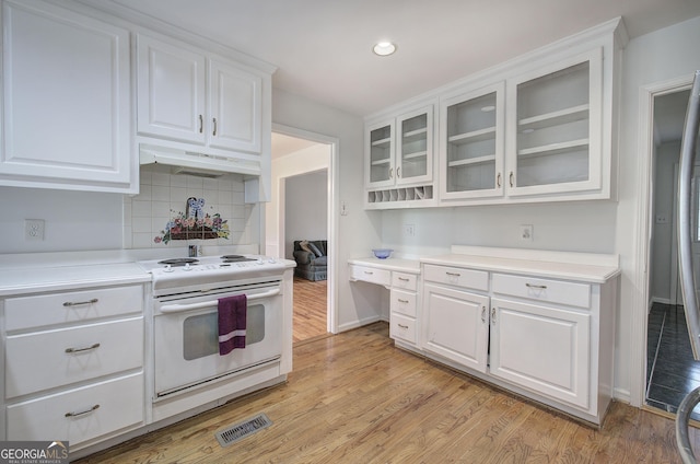 kitchen with white cabinetry, light wood-style flooring, white electric range oven, under cabinet range hood, and visible vents