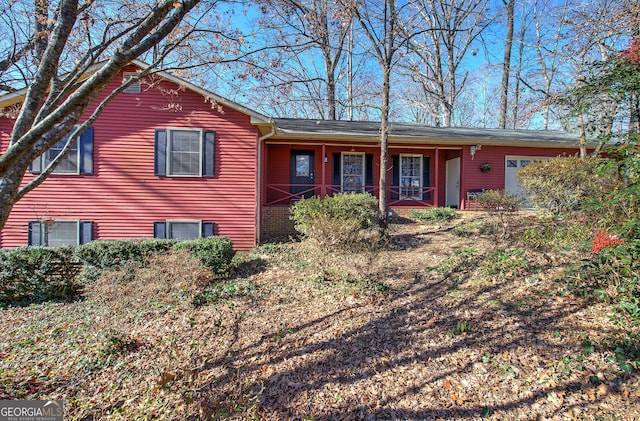 view of front of house with covered porch and a garage