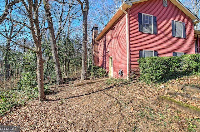view of side of home with a chimney