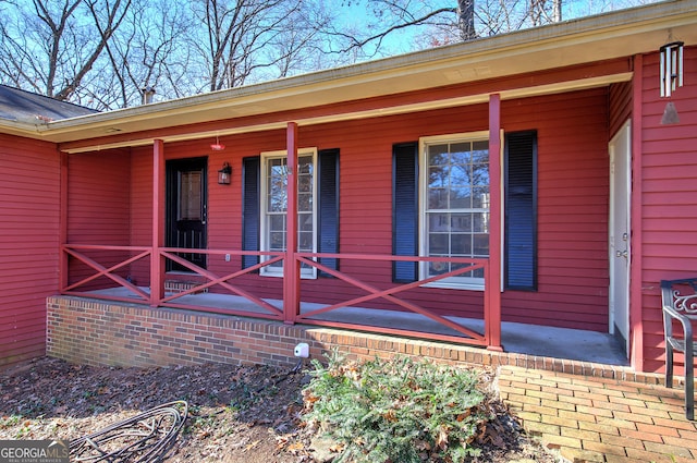 view of exterior entry with a porch