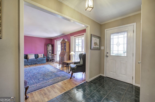 tiled entryway featuring crown molding