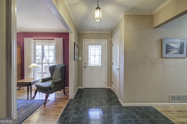 foyer entrance featuring dark hardwood / wood-style floors and crown molding