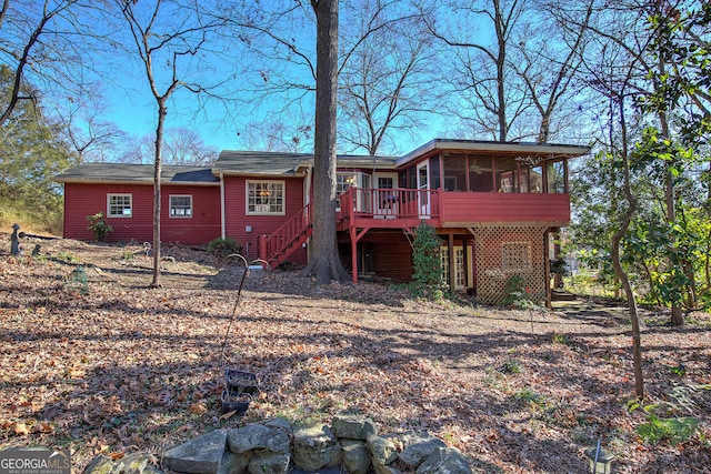 back of property featuring stairs and a sunroom