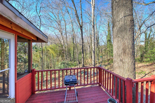 wooden deck featuring a grill