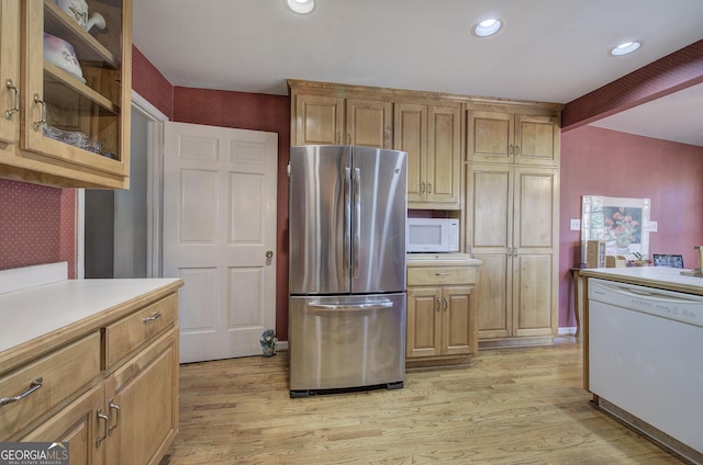 kitchen featuring white appliances, light hardwood / wood-style flooring, and beam ceiling