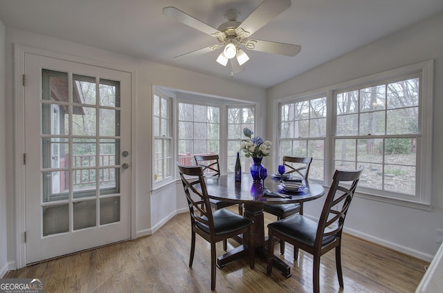 dining area featuring baseboards, wood finished floors, and ceiling fan
