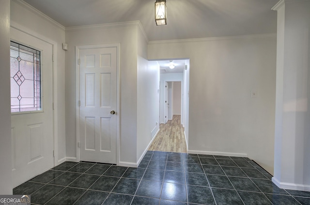tiled entrance foyer featuring baseboards and ornamental molding