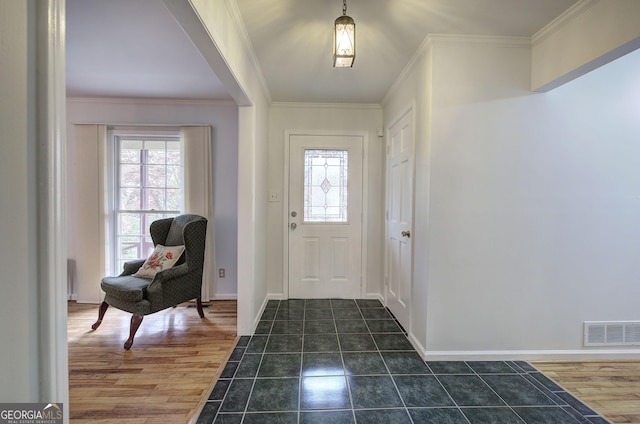 entryway with visible vents, crown molding, and plenty of natural light