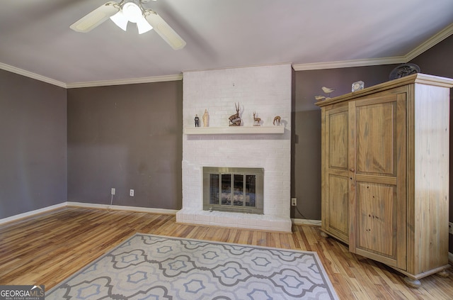 unfurnished living room featuring a fireplace, light wood-type flooring, ceiling fan, and ornamental molding